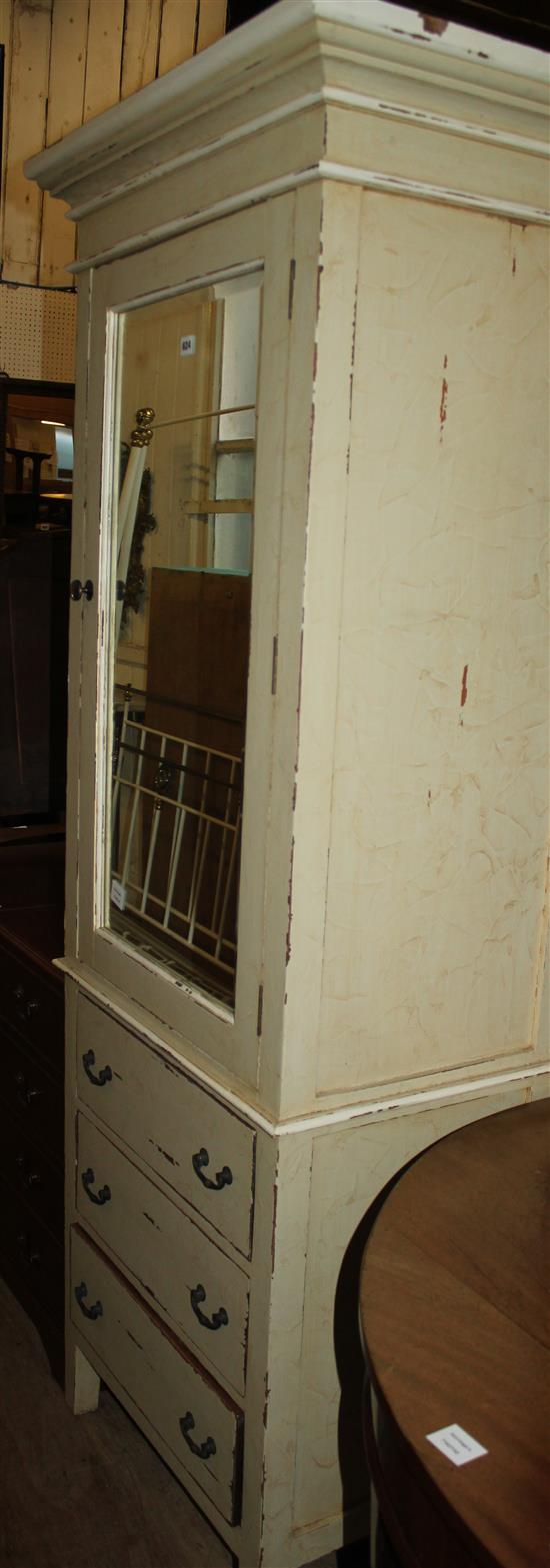 A painted mirror door cabinet